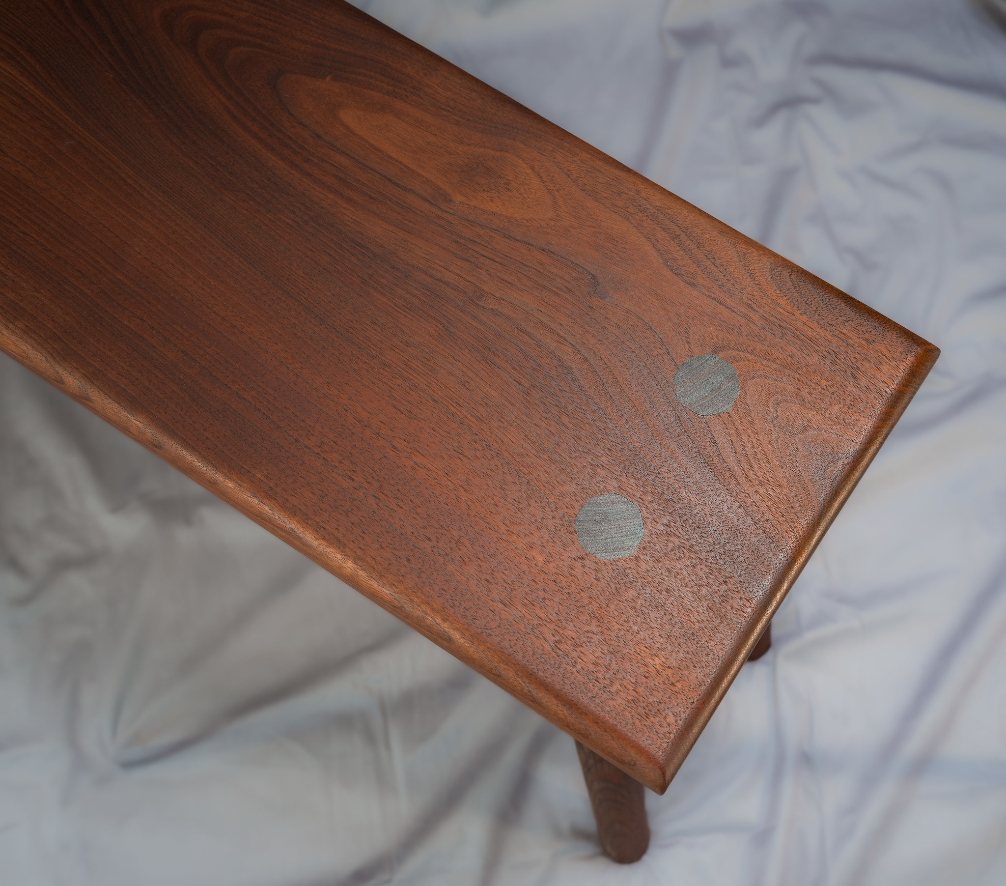 The legs are joined with octagonal through tenons. The octagons were a subtle nod to the way the angle of the angle of the legs on Japanese torii are calculated.