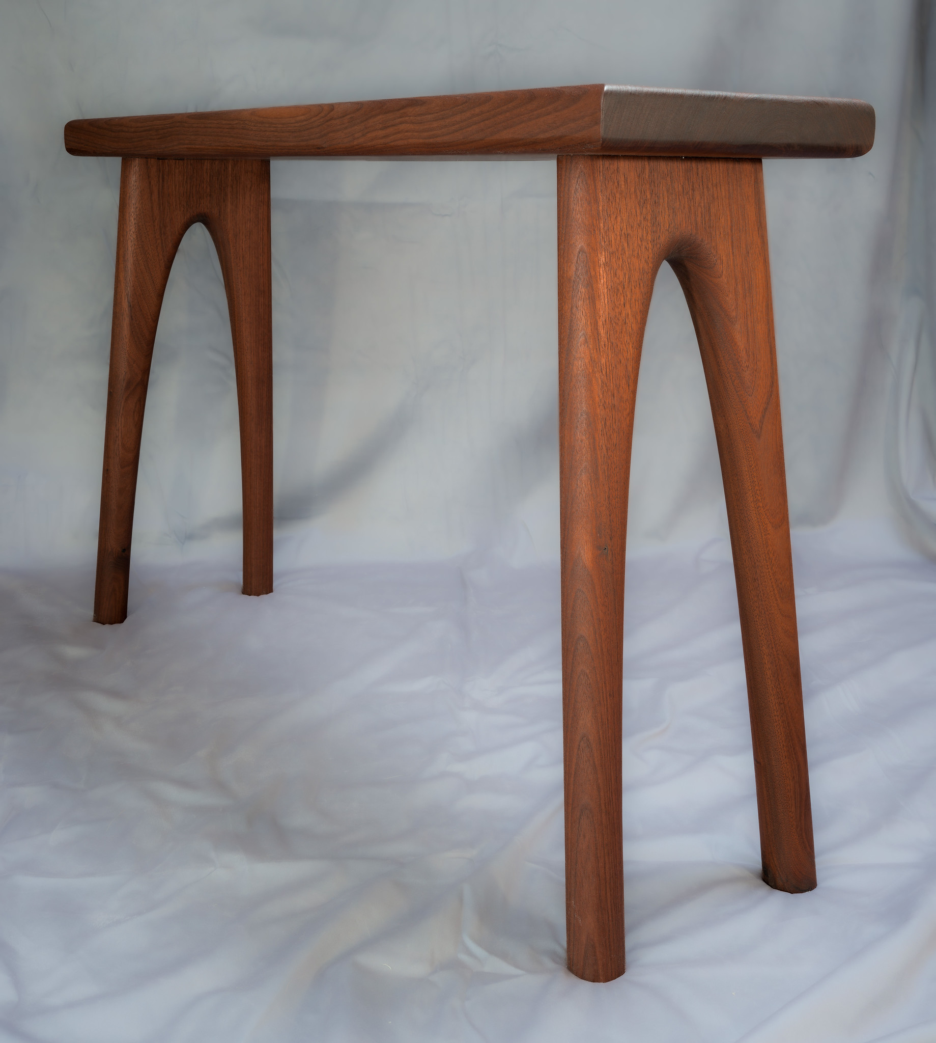 Designed to fit over a chair and be just big enough for a small laptop or other device.