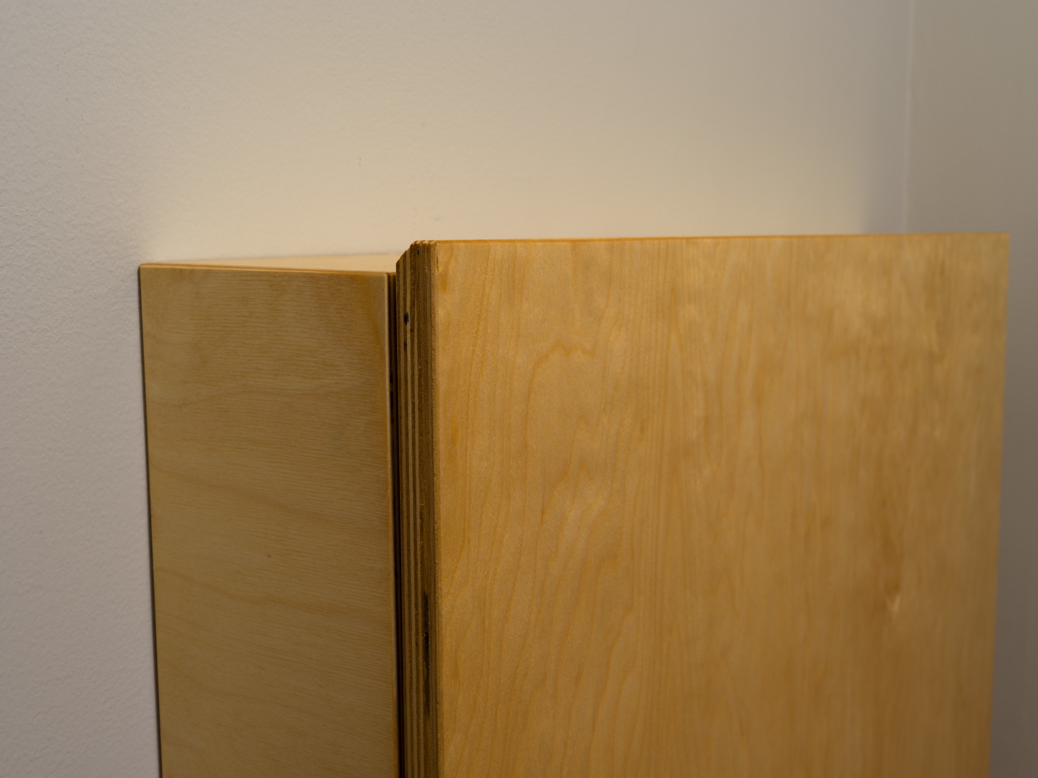 A convertible, fold-down desk. A detail view of the top of the desk portion. I used a 45 degree chamfer on the edge for comfort and as a call back to other pieces that have the same feature. Made from baltic birch.