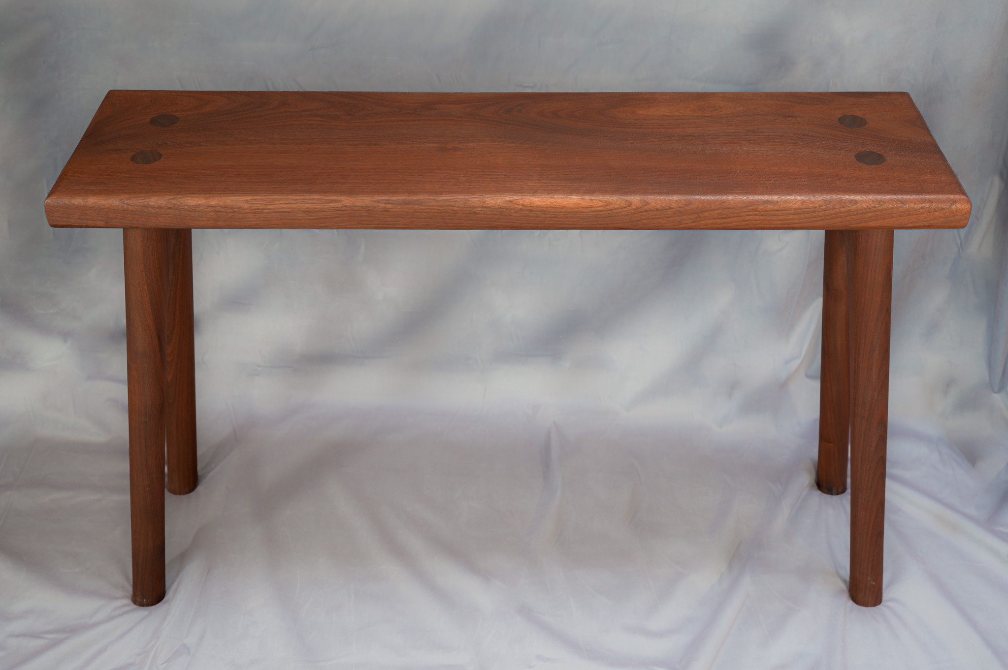 Perhaps silly, but the size was design to slide over a Poäng chair from Ikea. Though the height and width is relatively standard, so it's not tied to that chair. The pure lumber cost more than the original chair.